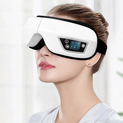 Woman wearing white eye massager with digital display and black strap indoors
