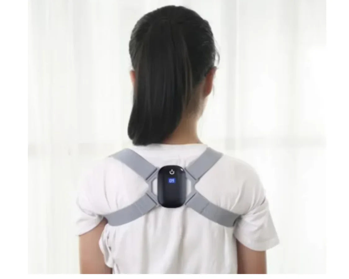 Woman wearing a gray electronic posture corrector with a digital display on her back