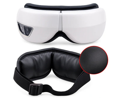 White electric eye massager with black adjustable strap and soft leather cushion close-up