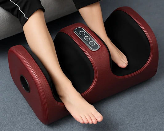 Feet using red and black electric foot massager on gray carpet near sofa