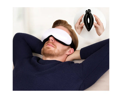Man wearing white eye massager mask relaxing on couch with inset showing black folded eye massager